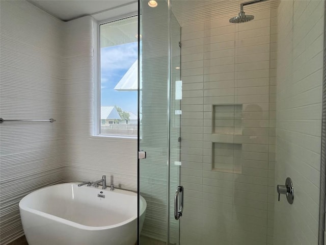 221 Blue Blaze Trl, Georgetown, TX 78628 - full bathroom with a stall shower, a soaking tub, and tile walls