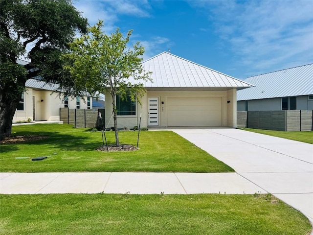 221 Blue Blaze Trl, Georgetown, TX 78628 - view of front of house featuring a standing seam roof, a garage, stucco siding, driveway, and metal roof