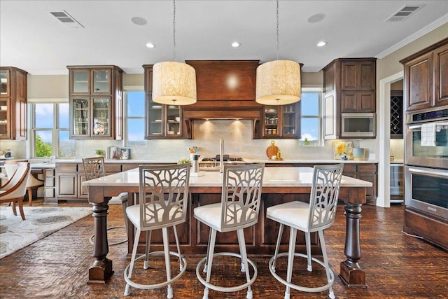 457 Santaluz Ln, Austin, TX 78732 - kitchen featuring appliances with stainless steel finishes, light countertops, backsplash, ornamental molding, and recessed lighting