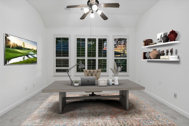 carpeted home office with vaulted ceiling, a ceiling fan, and baseboards