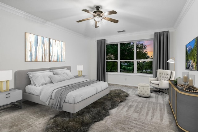 carpeted bedroom featuring crown molding, a ceiling fan, and baseboards