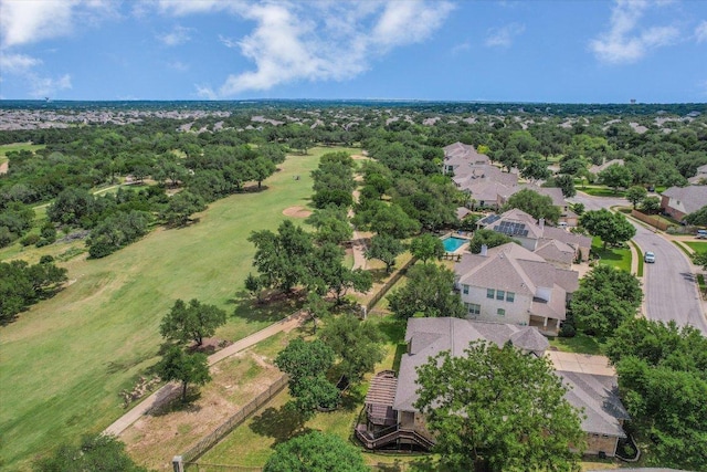 aerial view of residential area featuring a tree filled landscape