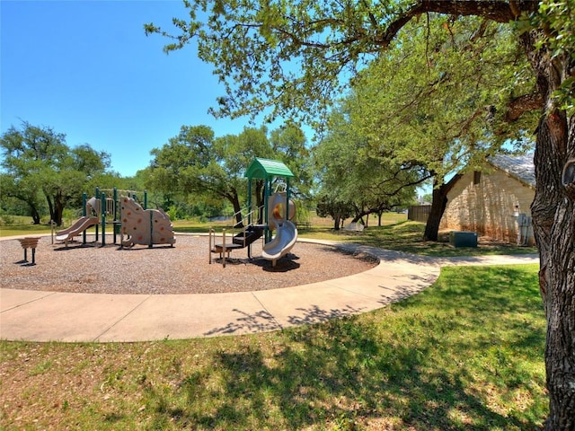 community playground featuring a lawn