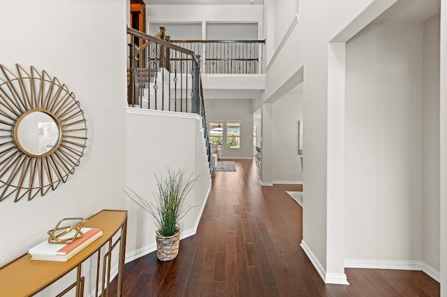 433 Vista Portola Loop, Liberty Hill, TX 78642 - hallway featuring wood finished floors, baseboards, stairs, and a towering ceiling