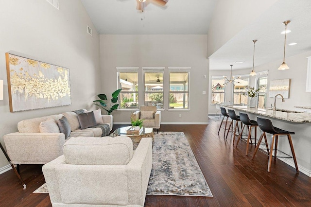 433 Vista Portola Loop, Liberty Hill, TX 78642 - living area with a ceiling fan, dark wood-type flooring, high vaulted ceiling, and baseboards