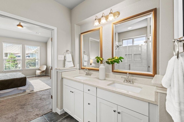 433 Vista Portola Loop, Liberty Hill, TX 78642 - full bath with a shower stall, double vanity, ensuite bathroom, tile patterned floors, and baseboards