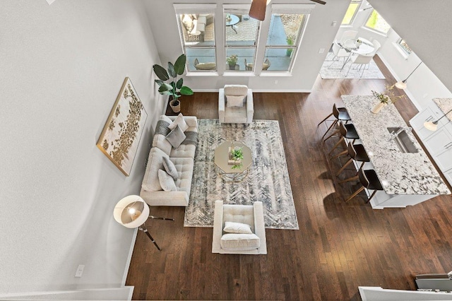 433 Vista Portola Loop, Liberty Hill, TX 78642 - living area featuring wood finished floors, baseboards, and a ceiling fan