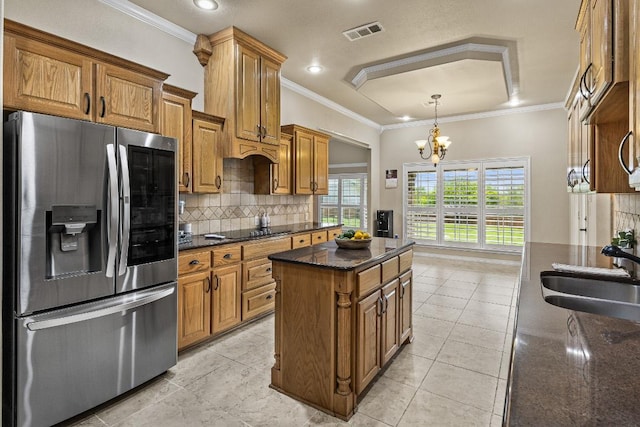 1420 Gomer Ln, Harker Heights, TX 76548 - kitchen with stainless steel fridge, brown cabinets, backsplash, black electric cooktop, and crown molding