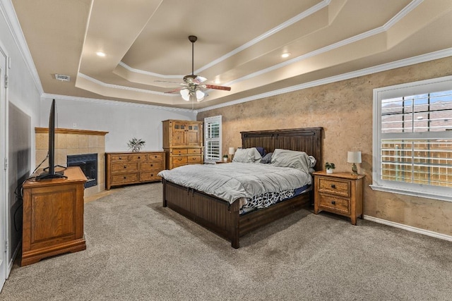 1420 Gomer Ln, Harker Heights, TX 76548 - carpeted bedroom with crown molding, a raised ceiling, a tiled fireplace, baseboards, and ceiling fan