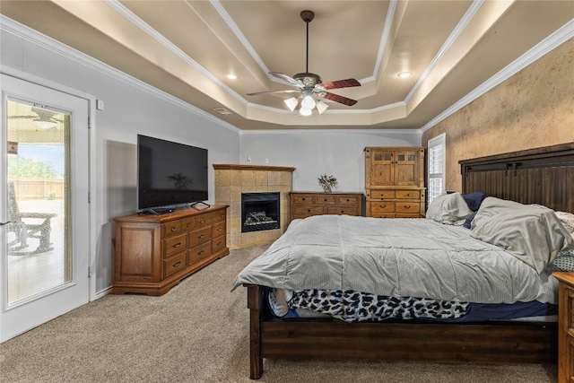 1420 Gomer Ln, Harker Heights, TX 76548 - bedroom featuring a tray ceiling, light colored carpet, ornamental molding, access to outside, and a tiled fireplace