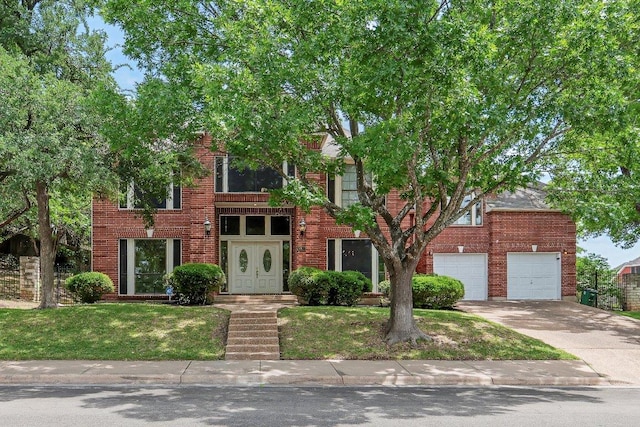 9002 Scotsman Dr, Austin, TX 78750 - view of front of house featuring driveway, brick siding, a garage, and a front yard