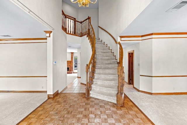 9002 Scotsman Dr, Austin, TX 78750 - foyer with stairway, baseboards, a high ceiling, a chandelier, and carpet flooring