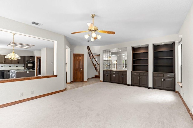9002 Scotsman Dr, Austin, TX 78750 - unfurnished living room with baseboards, light colored carpet, a ceiling fan, and stairway