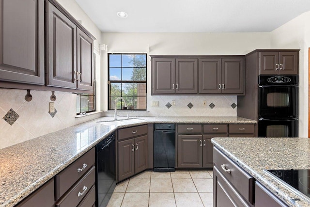 9002 Scotsman Dr, Austin, TX 78750 - kitchen featuring black appliances, light tile patterned floors, decorative backsplash, and light stone countertops