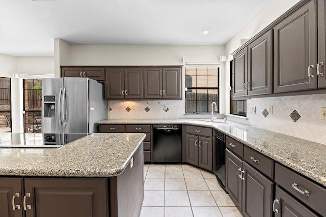 9002 Scotsman Dr, Austin, TX 78750 - kitchen featuring black appliances, a sink, healthy amount of natural light, and decorative backsplash