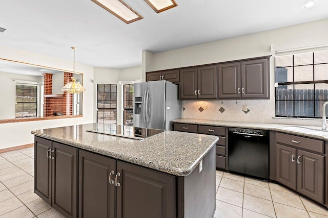 9002 Scotsman Dr, Austin, TX 78750 - kitchen with black appliances, a sink, a kitchen island, light tile patterned flooring, and decorative backsplash