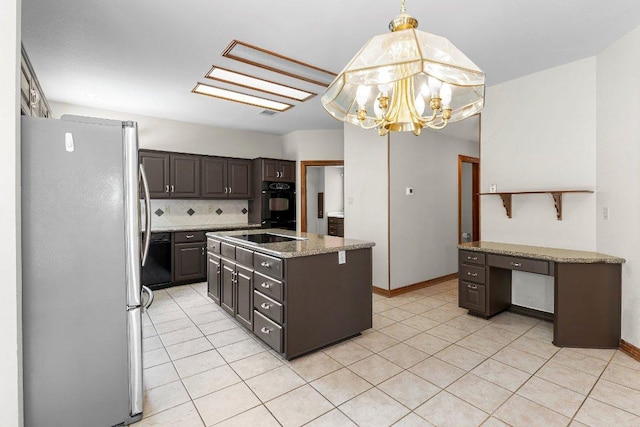 9002 Scotsman Dr, Austin, TX 78750 - kitchen with freestanding refrigerator, light tile patterned floors, a chandelier, and black electric stovetop