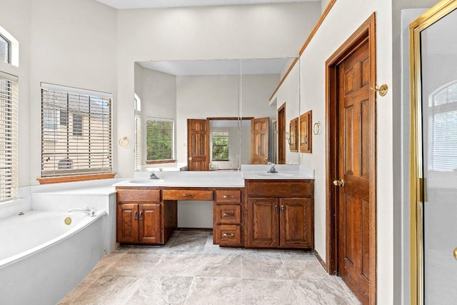 9002 Scotsman Dr, Austin, TX 78750 - bathroom featuring double vanity, plenty of natural light, and a garden tub