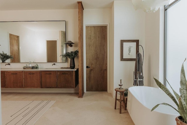 bathroom featuring a freestanding bath, double vanity, and tile patterned floors