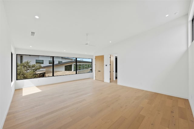 spare room featuring light wood-type flooring, recessed lighting, ceiling fan, and baseboards