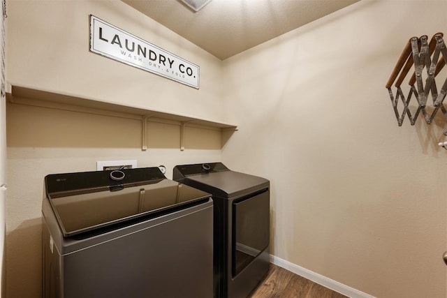 109 Dickinson Bayou Cv, Hutto, TX 78634 - laundry area with washing machine and dryer, wood finished floors, and baseboards
