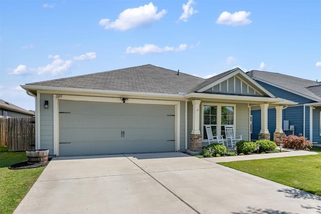 109 Dickinson Bayou Cv, Hutto, TX 78634 - view of front of house featuring covered porch, driveway, an attached garage, board and batten siding, and a shingled roof