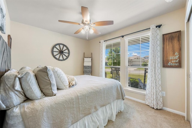 109 Dickinson Bayou Cv, Hutto, TX 78634 - bedroom featuring light colored carpet, baseboards, and a ceiling fan