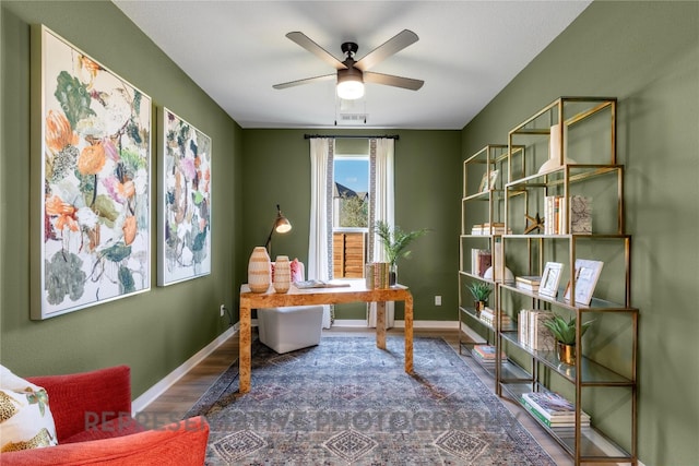 office with a ceiling fan, wood finished floors, and baseboards