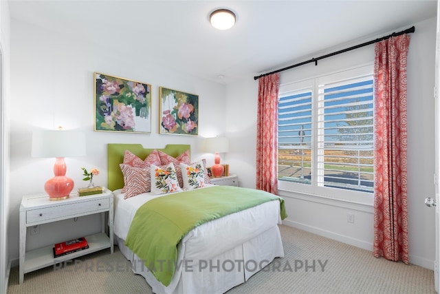 carpeted bedroom featuring baseboards