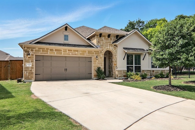 french country style house with stone siding, stucco siding, driveway, and an attached garage