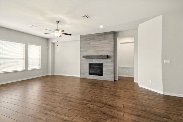 2300 La Mirada St, Leander, TX 78641 - unfurnished living room with ceiling fan, dark wood-style floors, baseboards, a tiled fireplace, and recessed lighting