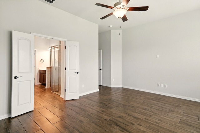 spare room with a ceiling fan, dark wood-style flooring, and baseboards