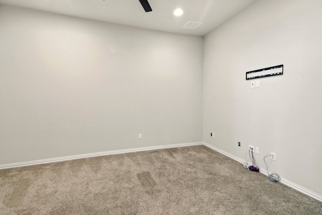 carpeted spare room with baseboards and ceiling fan