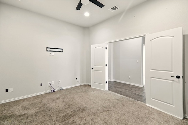 unfurnished bedroom featuring carpet flooring, baseboards, a high ceiling, ceiling fan, and recessed lighting