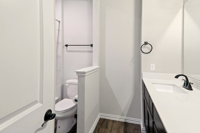 full bathroom with vanity, wood finished floors, toilet, and baseboards