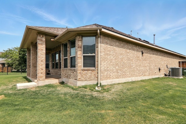 view of home's exterior featuring brick siding and central air condition unit