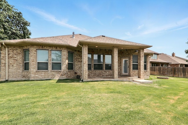 rear view of house featuring a patio and brick siding