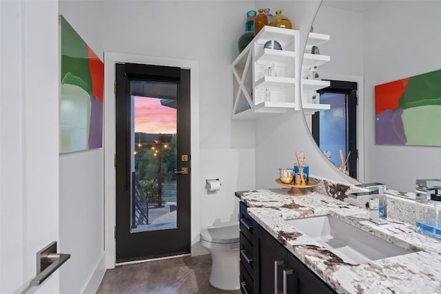 half bathroom featuring toilet and vanity