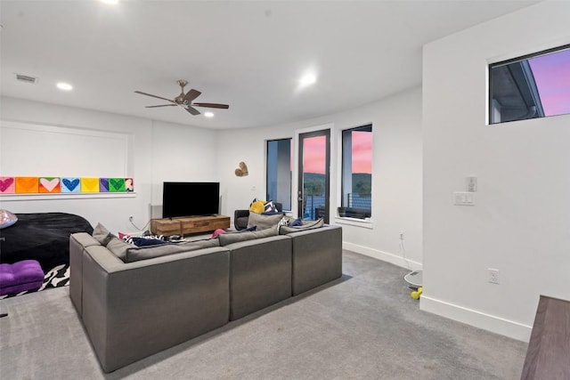 living room featuring carpet flooring, ceiling fan, baseboards, and recessed lighting