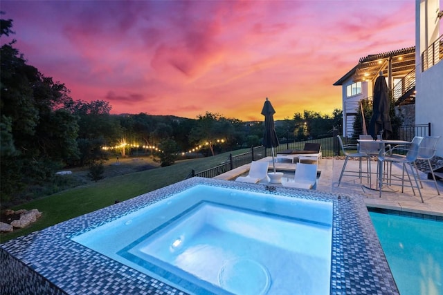 view of swimming pool featuring an in-ground hot tub and a patio