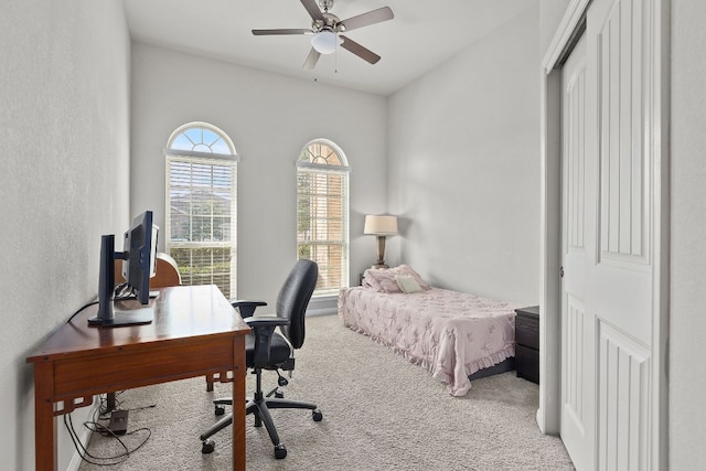 bedroom featuring carpet and an office area