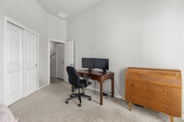 office space featuring carpet, baseboards, and high vaulted ceiling