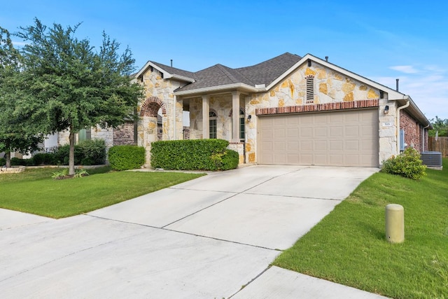 view of front facade with stone siding, an attached garage, a front lawn, concrete driveway, and central AC unit