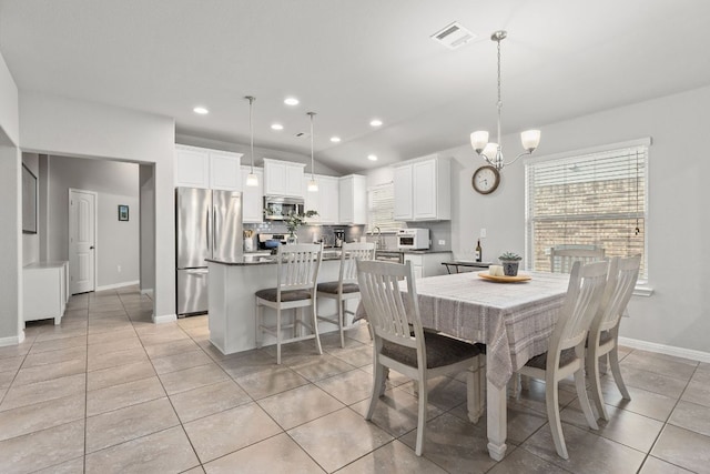 dining room featuring light tile patterned flooring, a chandelier, baseboards, recessed lighting, and lofted ceiling