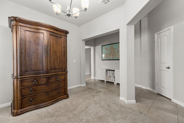 bedroom featuring a chandelier, light colored carpet, baseboards, and light tile patterned floors