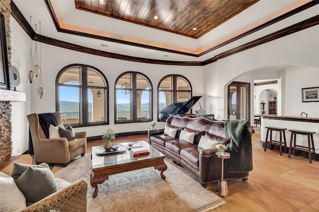 1710 Mount Larson Rd, Austin, TX 78746 - living area with arched walkways, a raised ceiling, crown molding, wood ceiling, and recessed lighting