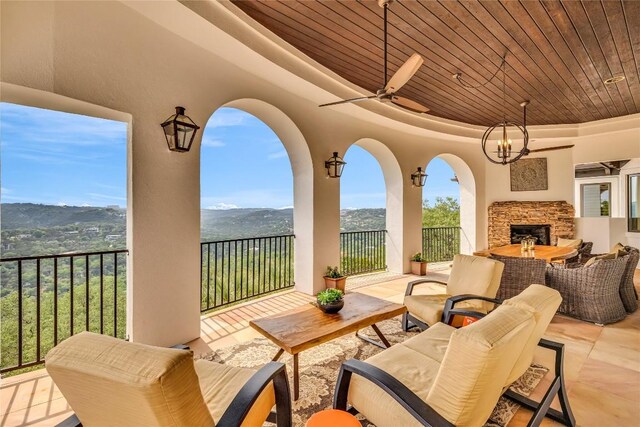 1710 Mount Larson Rd, Austin, TX 78746 - view of patio / terrace with an outdoor living space with a fireplace, a ceiling fan, and a mountain view