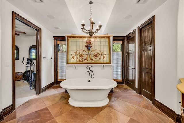 1710 Mount Larson Rd, Austin, TX 78746 - full bath with a soaking tub, a chandelier, and baseboards