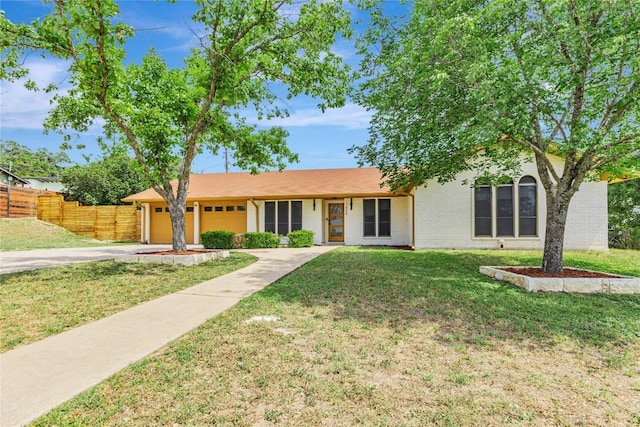 ranch-style house with concrete driveway, an attached garage, and brick siding