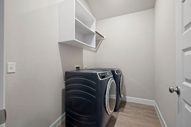 14505 Kira Ln, Manor, TX 78653 - washroom with washing machine and clothes dryer, baseboards, and wood finished floors